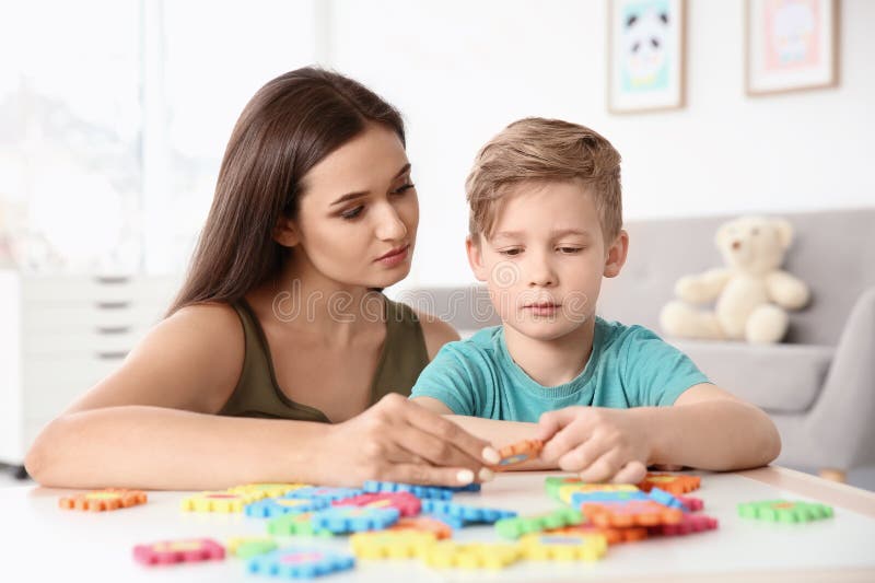 Young women and little boy with autistic disorder playing at home. Young women and little boy with autistic disorder playing at home