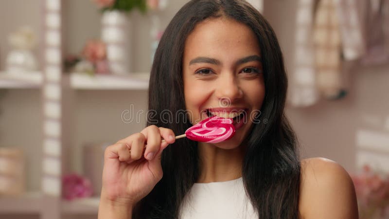 Mujer latina sonriente etnia alegre hispana joven hispana mimando a una chica atractiva mordiendo dulces comiendo dieta almacen de metraje de vídeo