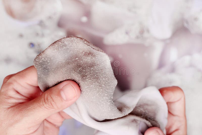 Woman washing dirty white socks by hand. Woman washing dirty white socks by hand.