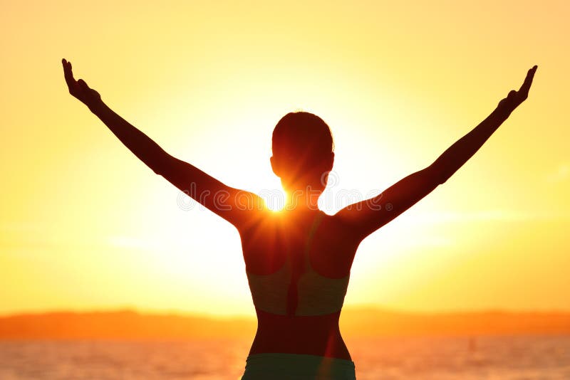 Freedom woman with open arms silhouette in sunrise against sun flare. Morning yoga girl practicing sun salutation outdoors. Carefree person living a free life. Success freedom happy life concept. Freedom woman with open arms silhouette in sunrise against sun flare. Morning yoga girl practicing sun salutation outdoors. Carefree person living a free life. Success freedom happy life concept.