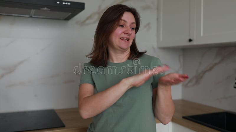 Mujer parada en la cocina sosteniendo un cuchillo