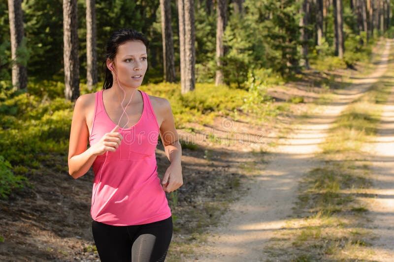 Mujer que corre con el entrenamiento al aire libre del bosque fotografía de archivo Mujer que corre con el entrenamiento al aire libre del bosque fotografía de archivo