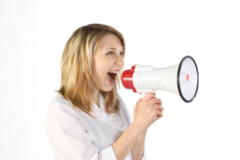 A young woman shouting into a megaphone. A young woman shouting into a megaphone.