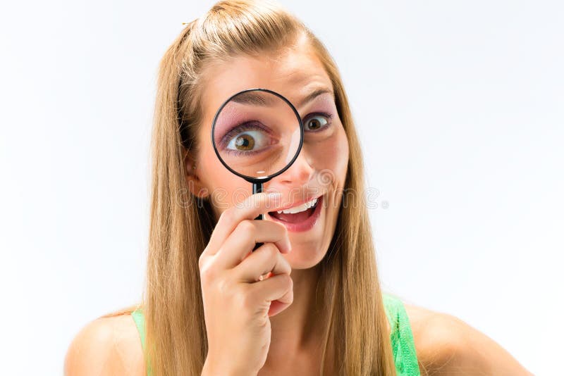 Woman looking through magnifying glass or loupe. Woman looking through magnifying glass or loupe