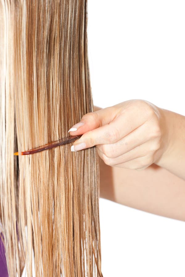 Woman combing hair on white isolated background. Woman combing hair on white isolated background