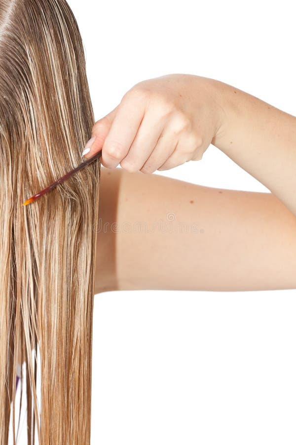 Woman combing hair on white isolated background. Woman combing hair on white isolated background