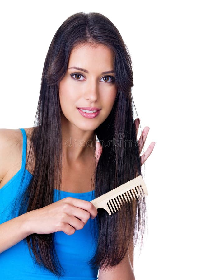 Portrait of beautiful young woman combing her long hair - isolated on white. Portrait of beautiful young woman combing her long hair - isolated on white