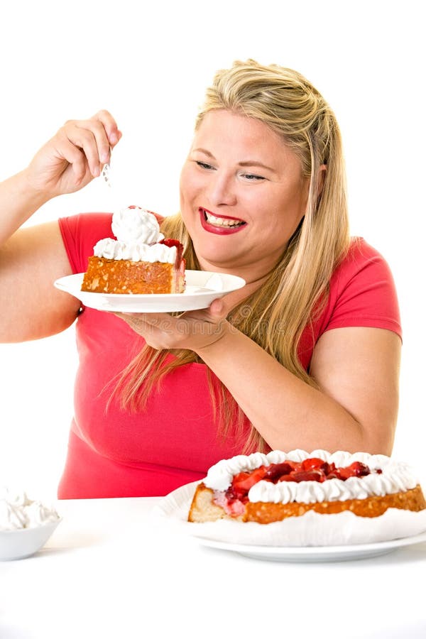Mujer rubia codiciosa con las tortas poner crema de la cebadura fotografía de archivo libre de regalías Mujer rubia codiciosa con las tortas poner crema de la cebadura fotografía de archivo libre de regalías