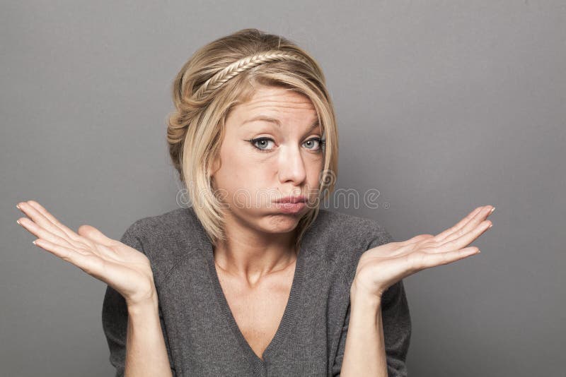 Negligence concept - bored young blond woman blowing her cheeks out with careless hand gesture,studio shot. Negligence concept - bored young blond woman blowing her cheeks out with careless hand gesture,studio shot