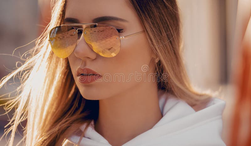 Mujer rubia joven y hermosa con gafas de sol amarillas en el exterior fotografía de archivo Mujer rubia joven y hermosa con gafas de sol amarillas en el exterior fotografía de archivo