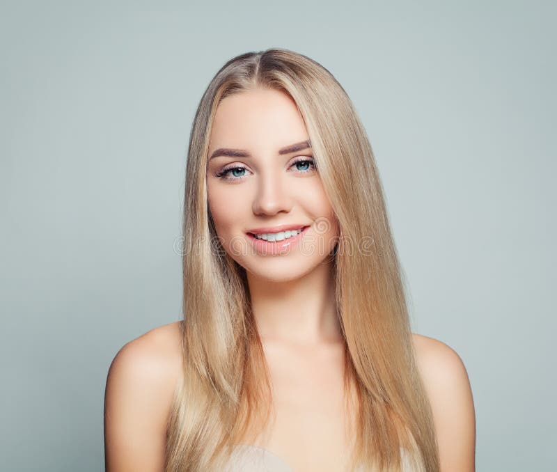 Smiling blonde woman with long healthy fair hair and clear skin. Facial treatment, haircare and cosmetology. Smiling blonde woman with long healthy fair hair and clear skin. Facial treatment, haircare and cosmetology.