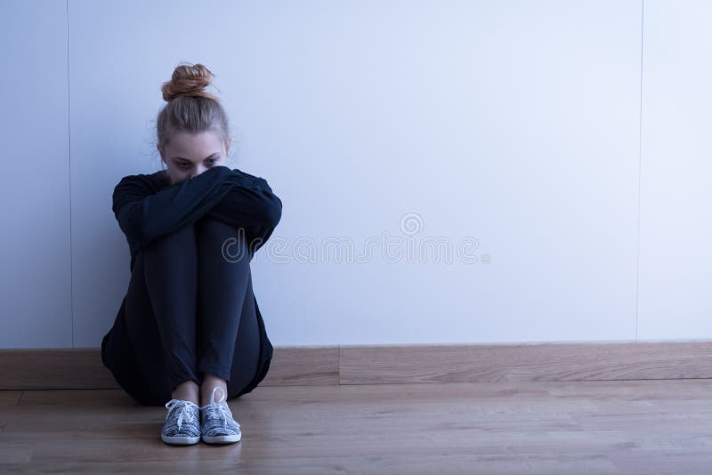 Sad woman with depression sitting on the floor. Sad woman with depression sitting on the floor