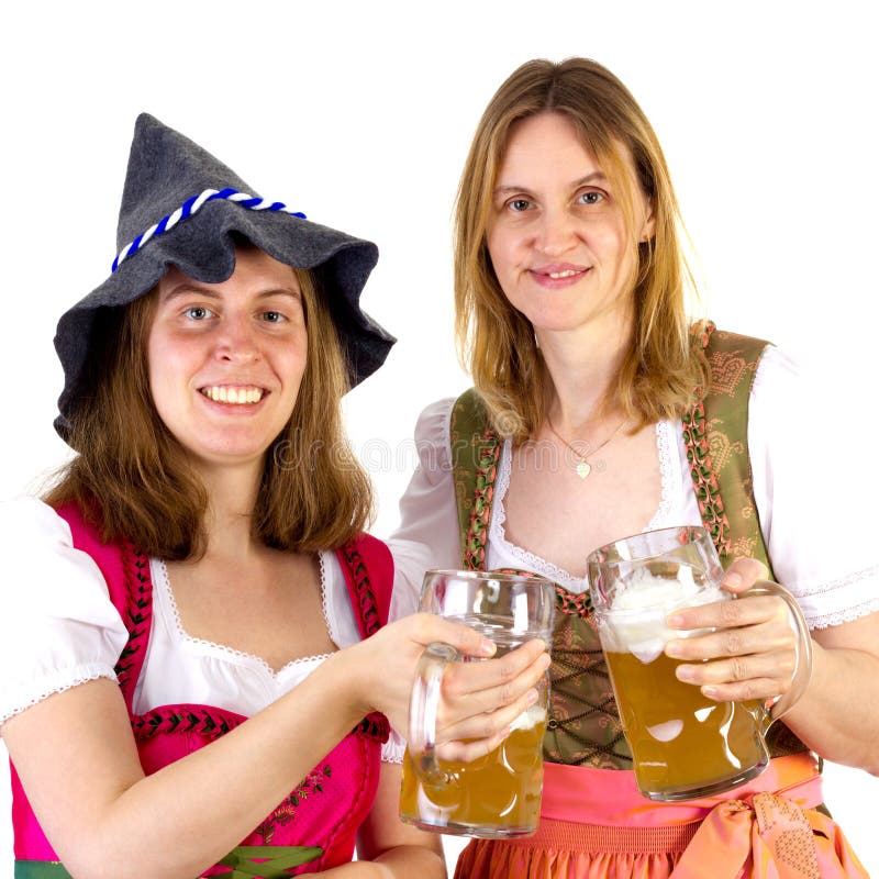 Mujeres en vidrios que tintinean del dirndl fotos de archivo Mujeres en vidrios que tintinean del dirndl fotos de archivo