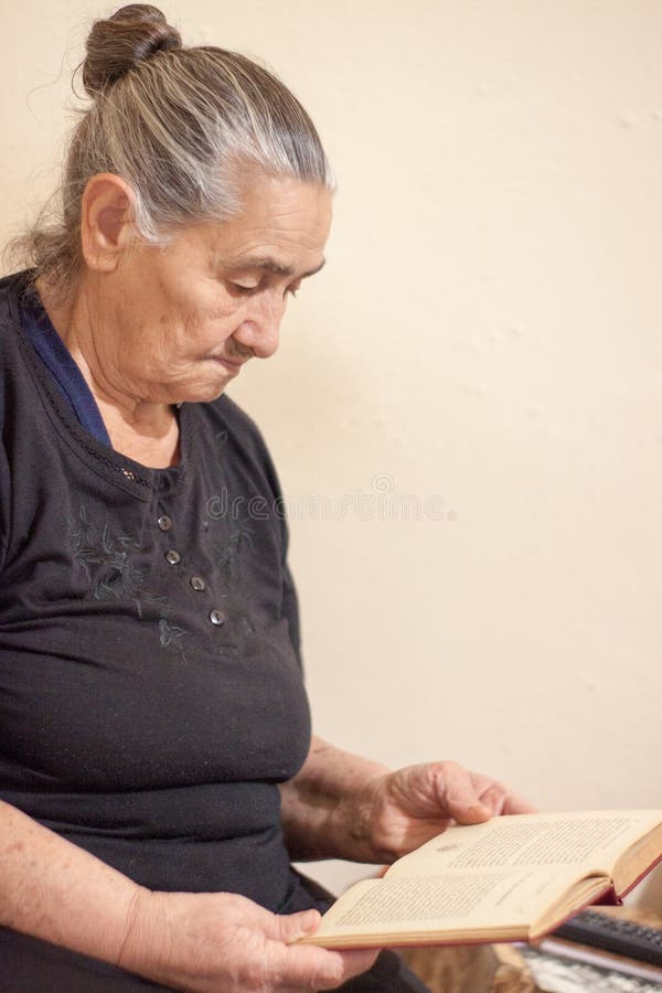 Mulher adulta que lê um livro imagem de stock Mulher adulta que lê um livro imagem de stock