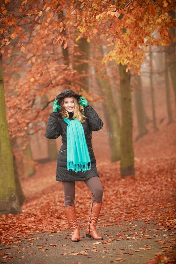 People, clohthing autumn season concept. Attractive woman in the park. Blonde female walking in autumnal forest, foggy misty day. People, clohthing autumn season concept. Attractive woman in the park. Blonde female walking in autumnal forest, foggy misty day