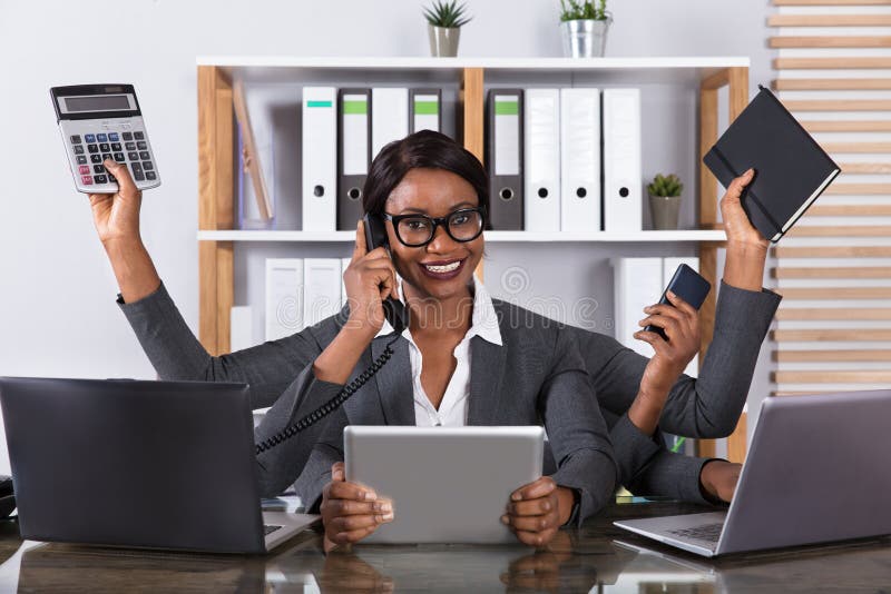 Mulher cansado que faz o trabalho a multitarefas no portátil imagens de stock Mulher cansado que faz o trabalho a multitarefas no portátil imagens de stock
