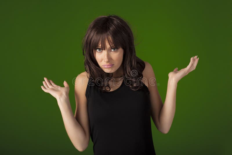 Young woman looking and feeling very confused over a green screen that can be replaced by any background. Young woman looking and feeling very confused over a green screen that can be replaced by any background.