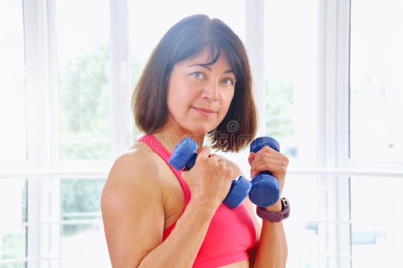 Mulher da aptidão que elabora com dumbbells fotografia de stock royalty free Mulher da aptidão que elabora com dumbbells fotografia de stock royalty free