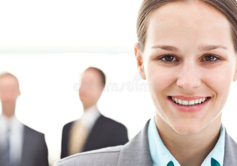 Mulher de negócios que levanta na frente de dois homens de negócios imagens de stock Mulher de negócios que levanta na frente de dois homens de negócios imagens de stock