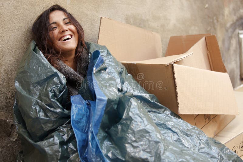 Happy poor woman wrapped with tarpaulin. Happy poor woman wrapped with tarpaulin