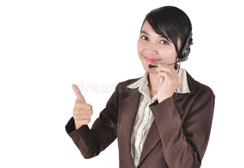 Mulher do centro de chamadas com os auriculares que mostram o polegar acima fotografia de stock Mulher do centro de chamadas com os auriculares que mostram o polegar acima fotografia de stock