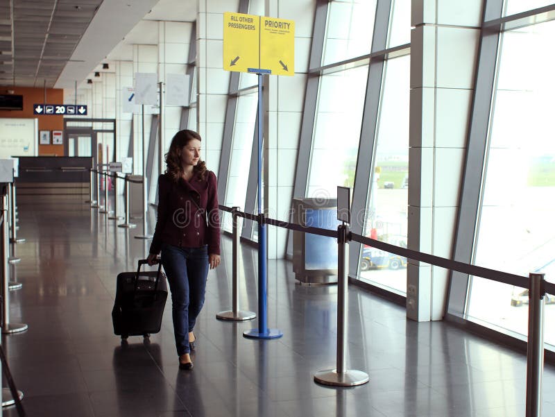 Travel woman with trolley bag on priority lane of the airport. Travel woman with trolley bag on priority lane of the airport