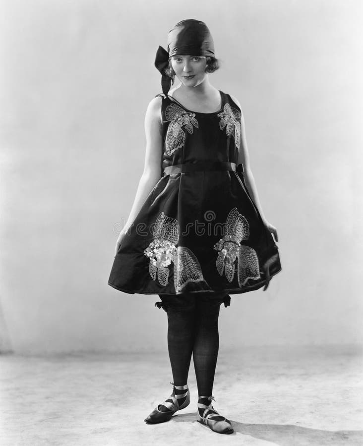 Mulher em um vestido florescido e em sapatas da bailarina (todas as pessoas descritas não são umas vivas mais longo e nenhuma pro imagem de stock Mulher em um vestido florescido e em sapatas da bailarina (todas as pessoas descritas não são umas vivas mais longo e nenhuma pro imagem de stock