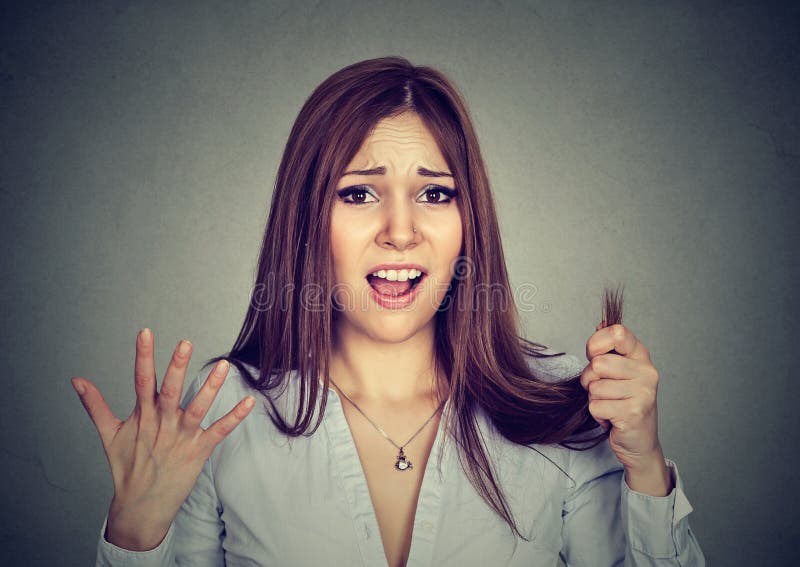 A mulher frustrante surpreendeu-a é extremidades rachadas do cabelo perdedor imagens de stock A mulher frustrante surpreendeu-a é extremidades rachadas do cabelo perdedor imagens de stock