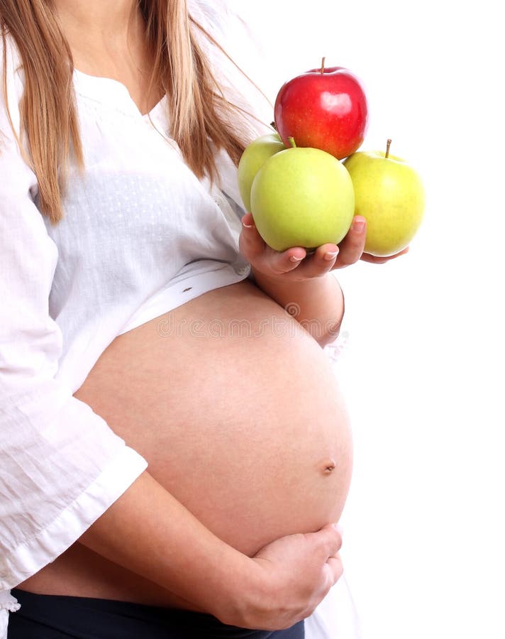 Mulher gravida com maçãs imagens de stock