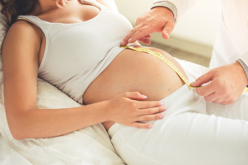 Mulher gravida que visita um doutor foto de stock Mulher gravida que visita um doutor foto de stock