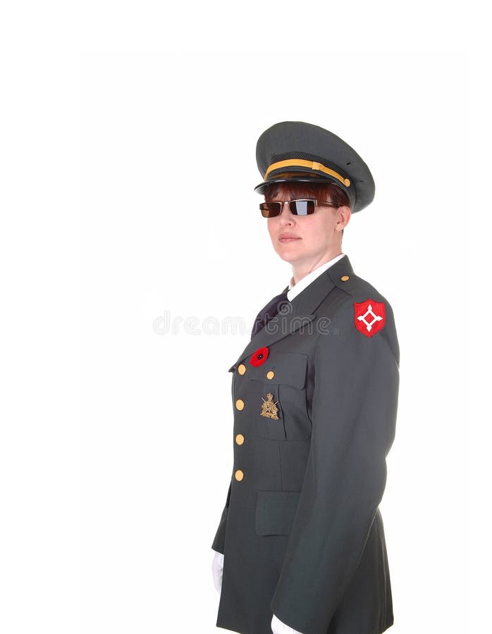 A tall woman in an military uniform and sunglasses standing in the studio with white cloves for white background. A tall woman in an military uniform and sunglasses standing in the studio with white cloves for white background.