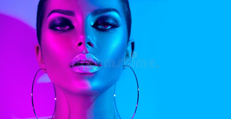 Mulher moreno do modelo de forma nas luzes de néon brilhantes coloridas que levantam no estúdio Menina 'sexy' bonita, composição