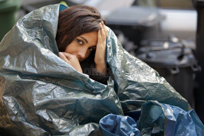 Poor young woman wrapped in plastic tarpaulin. Poor young woman wrapped in plastic tarpaulin