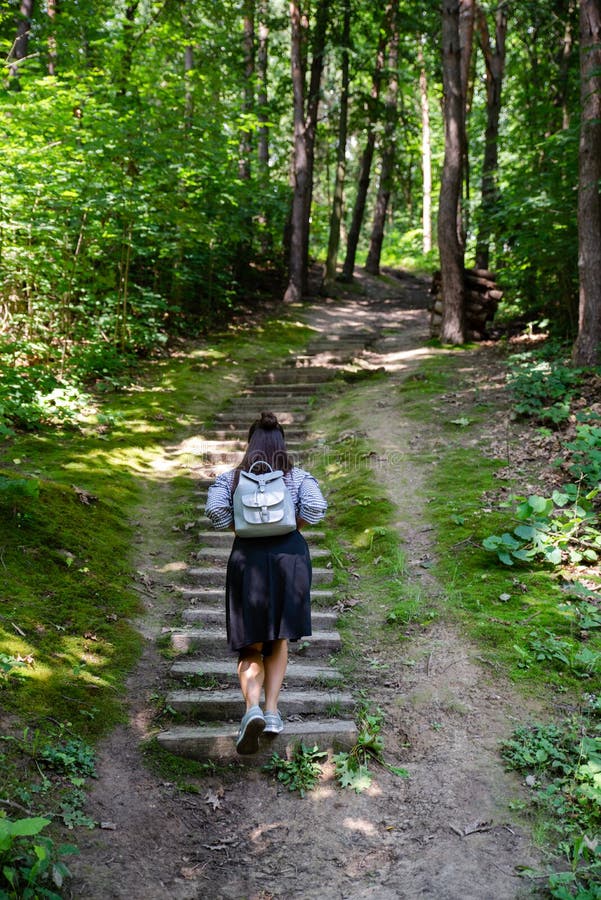 mulher que anda acima por escadas velhas na floresta imagem de stock mulher que anda acima por escadas velhas na floresta imagem de stock