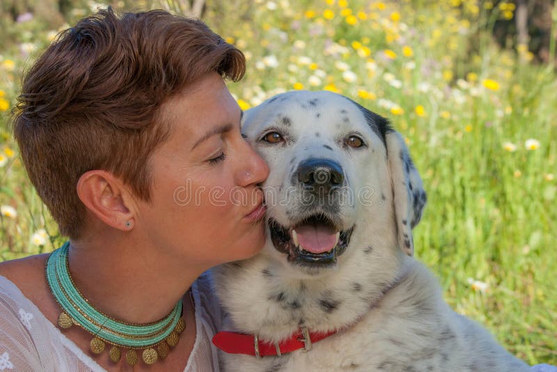 Mulher que beija o cão do salvamento do animal de estimação foto de stock Mulher que beija o cão do salvamento do animal de estimação foto de stock