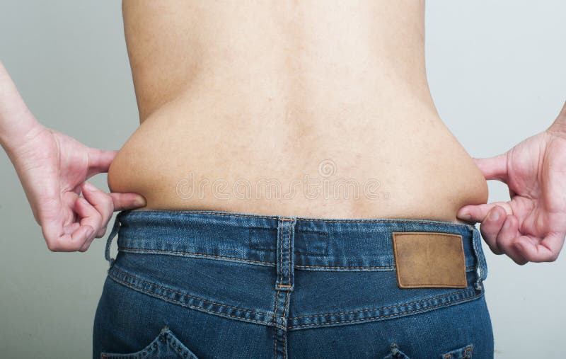 Mulher que comprime gorda de sua cintura fotos de stock royalty free Mulher que comprime gorda de sua cintura fotos de stock royalty free