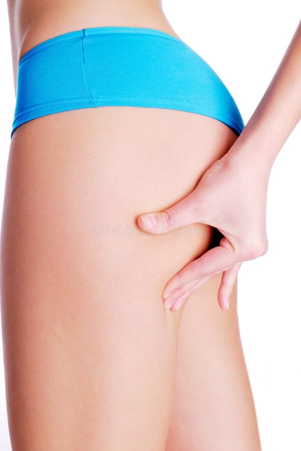 Woman pinching leg for skin fold test - studio shot on white. Woman pinching leg for skin fold test - studio shot on white