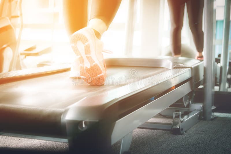 Mulher que corre em um gym em um conceito da escada rolante para exercitar, fi foto de stock Mulher que corre em um gym em um conceito da escada rolante para exercitar, fi foto de stock
