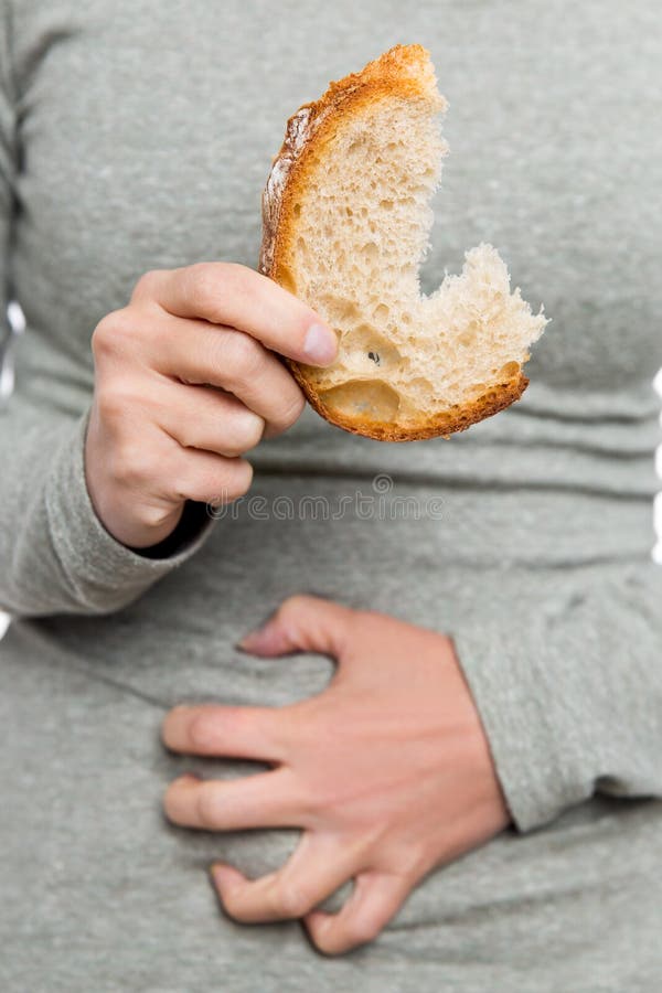 Woman holding wheat bread, celiac disease or coeliac condition, abdominal pain. Woman holding wheat bread, celiac disease or coeliac condition, abdominal pain