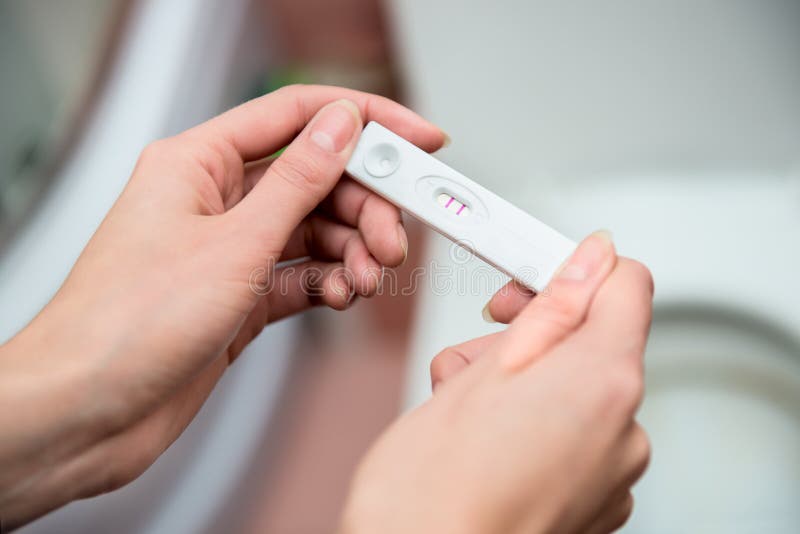 Woman honding negative pregnancy test in hands. Woman honding negative pregnancy test in hands