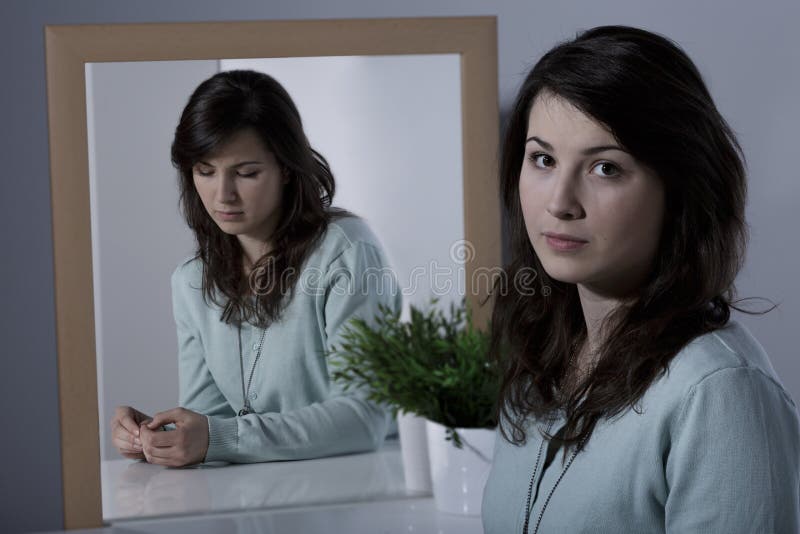 Depressed lonely woman repressing her real emotions. Depressed lonely woman repressing her real emotions