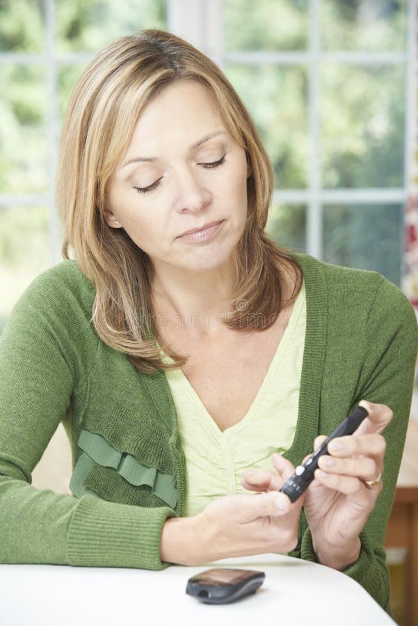 Concerned Woman Checking Blood Sugar Level At Home. Concerned Woman Checking Blood Sugar Level At Home