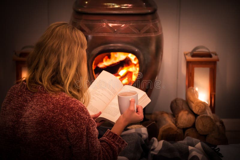 Holiday in winter time in front of the fireplace reading a book. Holiday in winter time in front of the fireplace reading a book.