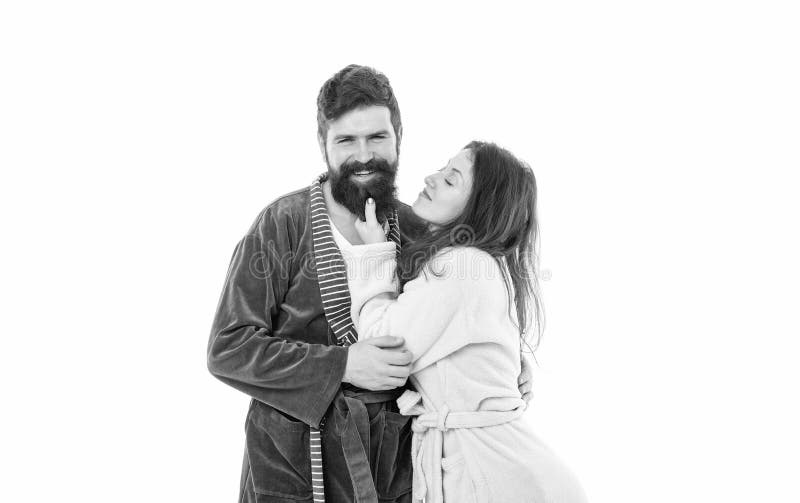 Sleepy woman touch beard of happy family man in robes isolated on white, couple. Sleepy woman touch beard of happy family man in robes isolated on white, couple.