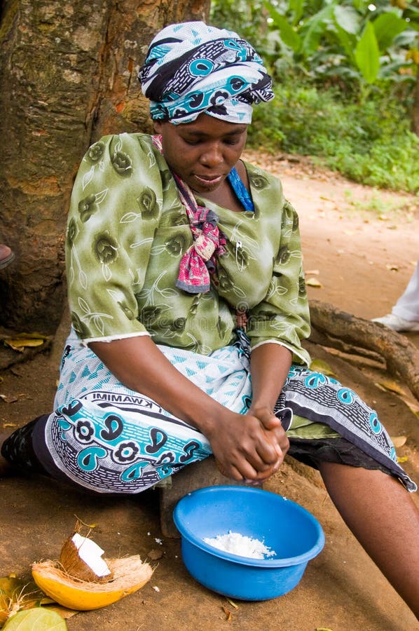 Zanzibar Tanzania 14/08/2010: Coconut processing,woman scrapes the coconut from the nut. Zanzibar Tanzania 14/08/2010: Coconut processing,woman scrapes the coconut from the nut