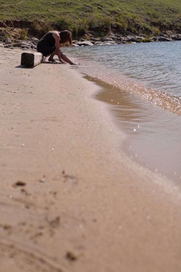 Mulher triste sentada na praia