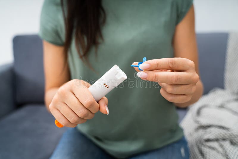 Woman Using Auto-injector Syringe As An Emergency Treatment For Allergic Reaction. Woman Using Auto-injector Syringe As An Emergency Treatment For Allergic Reaction