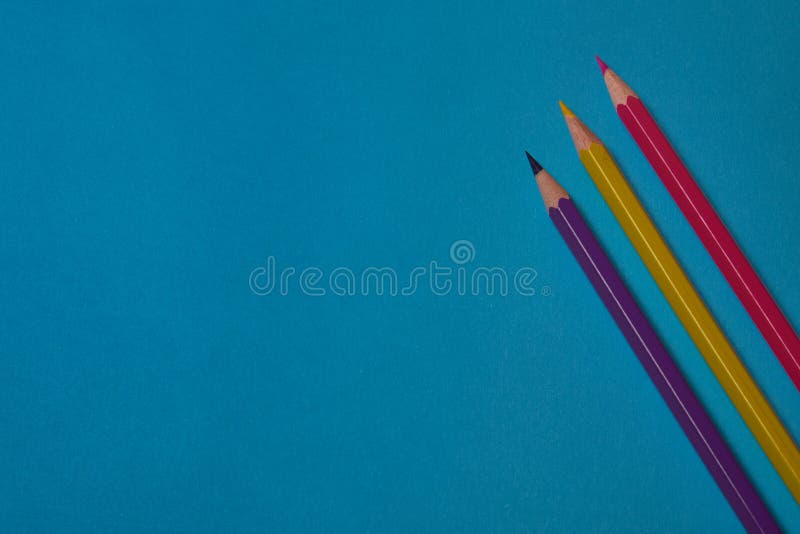Multi Colored Crayons at Blue Background with Copy Space Stock Photo