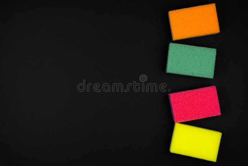New multi-colored foam sponges on a black background. Multi colored foam sponges stock images, royalty-free photos and pictures