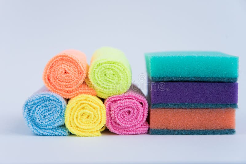 Multi-colored foam sponges for washing dishes and microfiber cloths. All multicolored items on a white background. Items for home cleaning. Multi colored foam sponges stock images, royalty-free photos and pictures
